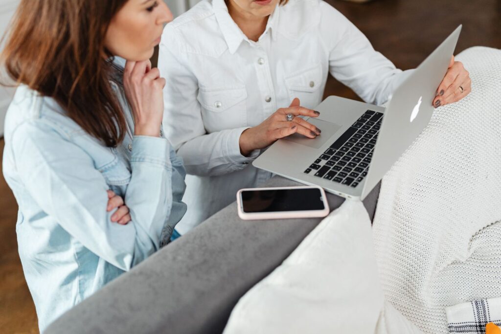 two women reviewing information on a laptop
